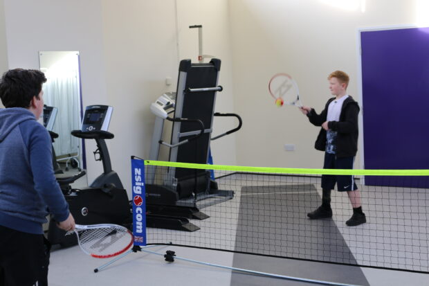 Ben playing tennis at the Brighton Limb Centre with a friend 